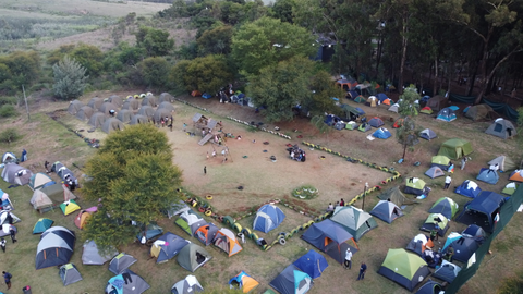 Tents gathered around the open space at camp