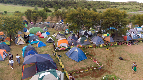 Participants walking through the campsite