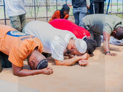 Participants kneeling in prayer