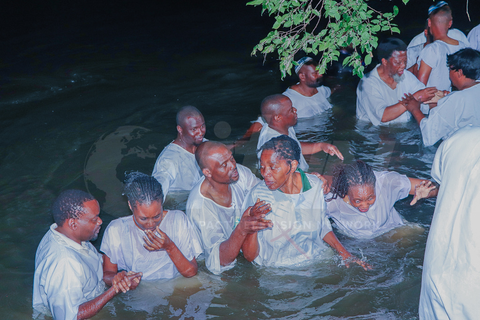Participants gathered in the water for baptism